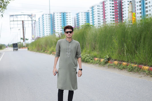 a man standing on the side of a road