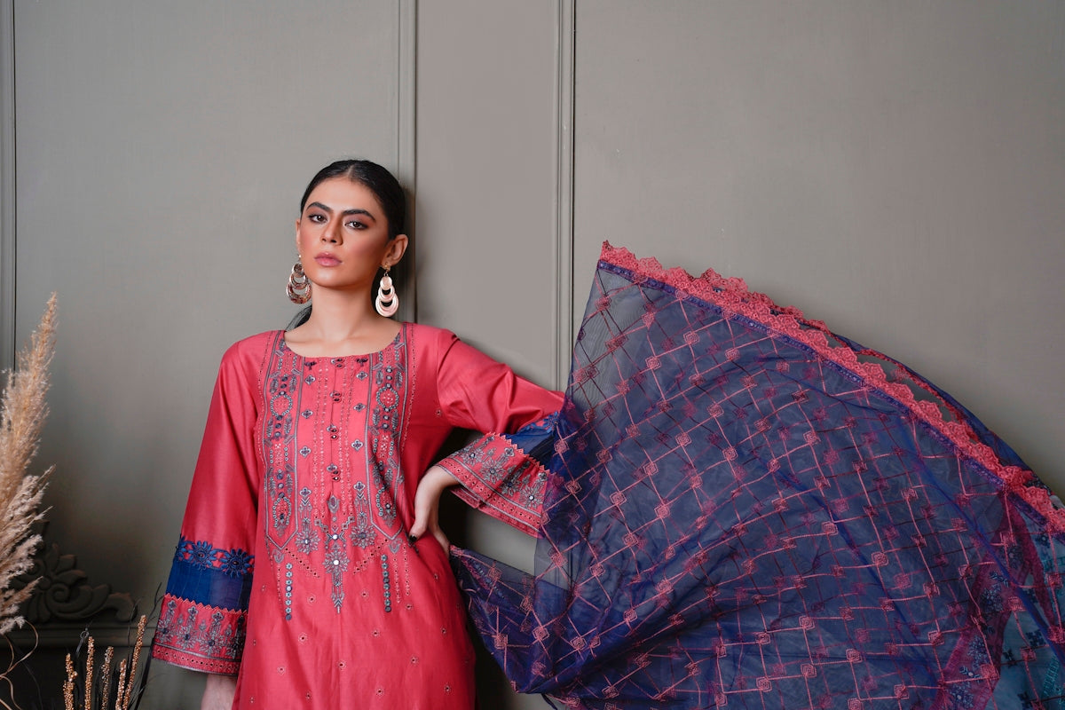 a woman standing next to a wall holding an umbrella